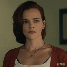 a close up of a woman 's face with a netflix logo on the bottom right