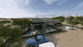 a blue car is parked in front of a house in the desert