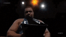 a person is holding a cell phone in front of a screen that says nxt on it