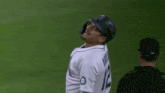 a baseball player wearing a jersey that says mariners on it