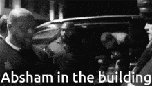 a black and white photo with absham in the building written in white