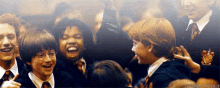 a group of harry potter characters are smiling together
