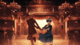 a man in a suit and a woman in a blue dress are dancing