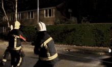 a blurred image of a fireman wearing a helmet and gloves