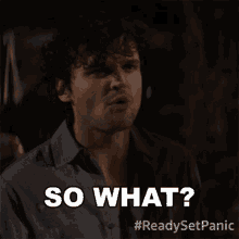 a man with curly hair is making a funny face and says so what