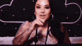 a woman with a tattoo on her arm is sitting in front of a star wars sign