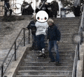 a person wearing a shirt that says reebok is walking up a set of stairs