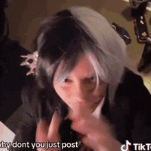 a woman with a wig on her head is making a funny face and says `` why dont you just post '' .