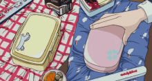 a person is putting something in a pink container that says peachy rice