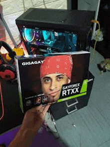 a person is holding a box with a picture of rick owens on it in front of a computer .
