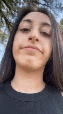 a close up of a woman making a funny face with her mouth open .