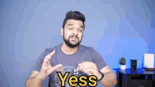 a man with a beard is wearing a shirt that says yess on it