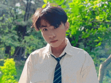 a young man wearing a white shirt and tie