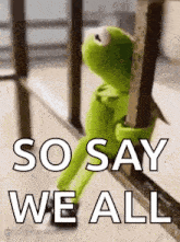 kermit the frog is sitting on a railing and holding onto a railing .