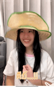 a girl wearing a hat that looks like a slice of apple