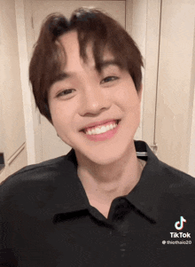 a tiktok video of a young man with a black shirt