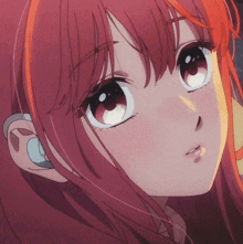 a close up of a girl 's face with red hair and big eyes