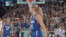 a female basketball player wearing a france jersey