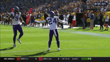 a football player wearing a number 24 jersey stands on the field