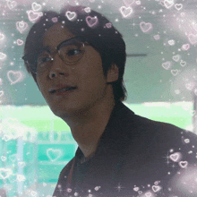 a man with glasses is surrounded by hearts and stars