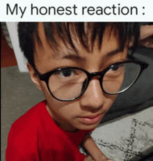 a boy wearing glasses and a red shirt with the words my honest reaction