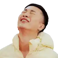 a man wearing a yellow jacket is laughing with his mouth open