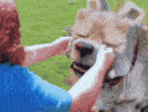 a woman is petting a statue of a lion .