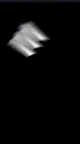 a blurred image of a person 's face in a dark room .