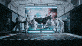 a group of people are standing around a horse in a room with a large screen behind them that says " the greatest " on it