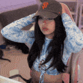 a girl wearing a san francisco giants hat