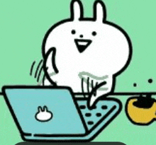a cartoon rabbit is sitting at a table using a laptop computer .