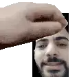 a hand is touching a man 's face in a pixel art .