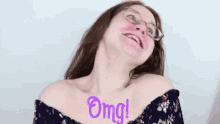 a woman wearing glasses is making a funny face and the word omg is written on her chest .