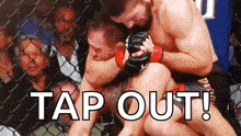 two men are fighting in a cage with the words tap out written below them