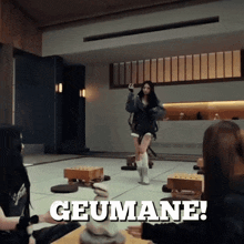 a group of people sitting around a table with the word geumane written on the floor