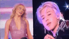 a woman in a pink dress and a man with purple hair are standing next to each other on a stage .