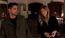 a man and a woman are looking at each other