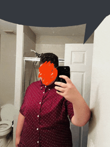 a man taking a selfie in a bathroom with a red circle around his face