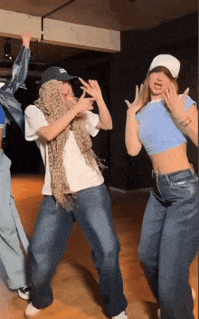 a group of young people are dancing in a room .