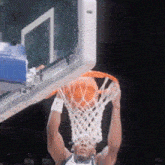 a man is dunking a basketball into the net
