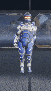 a man in a blue and white armor is standing in front of a mountain