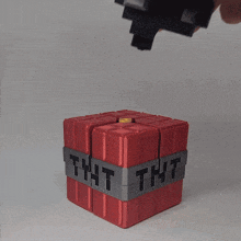 a person is holding a toy that says tnt