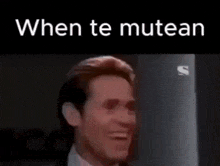a man in a suit and tie is looking at the camera with the words `` when te mutean '' written above him .