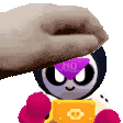 a person is petting a cartoon character with a purple mask on his face .