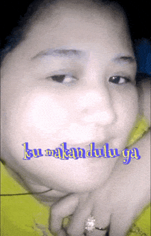 a close up of a woman 's face with the words ku makan dulu ga on it