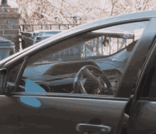 a car with the door open and a steering wheel