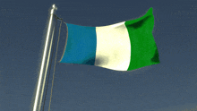 a blue white and green flag is flying on a pole