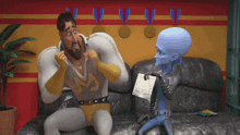 a man in a wrestling outfit is sitting on a couch talking to a man in a blue suit