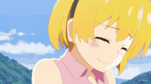 a girl with yellow hair and a pink shirt is smiling with her eyes closed