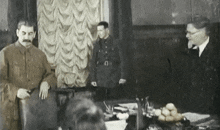 a man with a mustache stands in front of a group of people